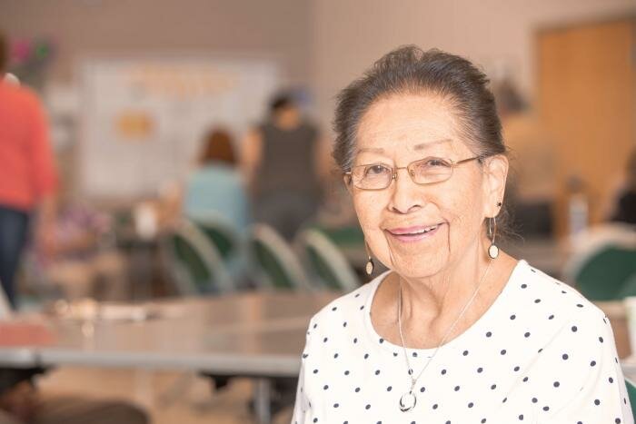 An older smiling woman.