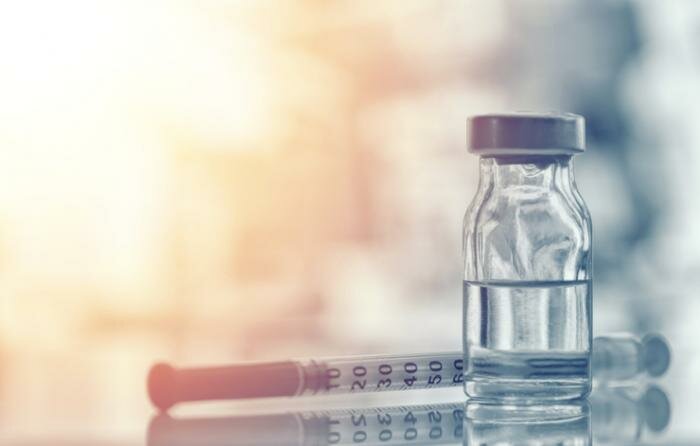 A needle and vial.