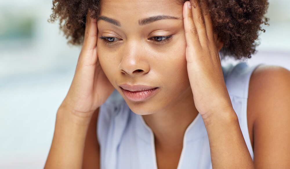 Photo of a woman looking like she is in pain.